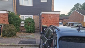 A black Hyundai car parked in front of a two-story house with a brick facade and a number 87 sign. - Delightful Ipswich Town 3 Bed House awaits you. (Ipswich)