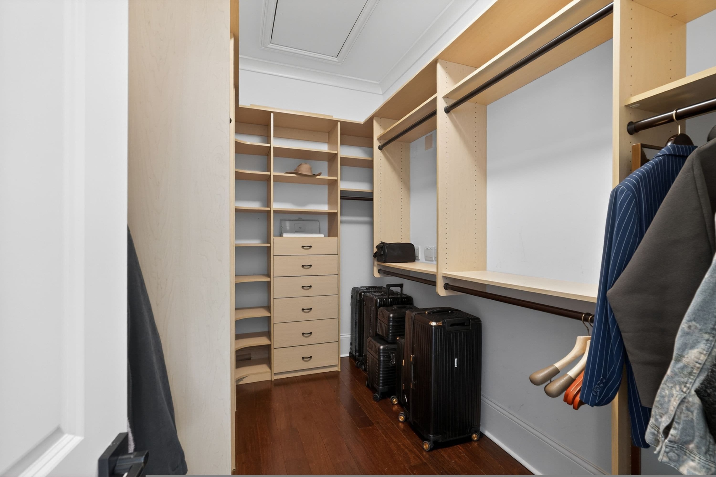 A walk-in closet with open shelving, a hanging rod, and a shoe rack.