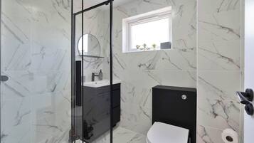 Shower, hair dryer, towels, shampoo