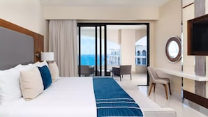 A hotel room with a large bed, a desk, a chair, and a TV. - Luxury Ocean Front Suite (San José del Cabo)