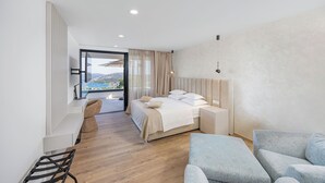 A modern hotel room with a bed, a desk, a chair, and a view of the outdoors. - View villas collection - 5 star Villa Blue horizon, pure luxury and comfort (Vinišće)