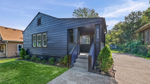 A single-story house with a front porch, a visible number '523' on the side, and a well-maintained lawn. - Independence House Near GEHA Field & Fenced Yard (Independence)