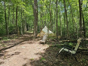 A forest campsite with a tent, a chair, and a path. - The Prospect | Mountain Glamping (Turtletown)
