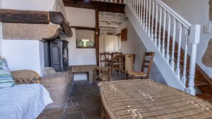 A rustic interior with a stone fireplace, wooden furniture, and a staircase. - Le Barrinal - MAS-SAINT-CHELY (MAS-SAINT-CHELY)