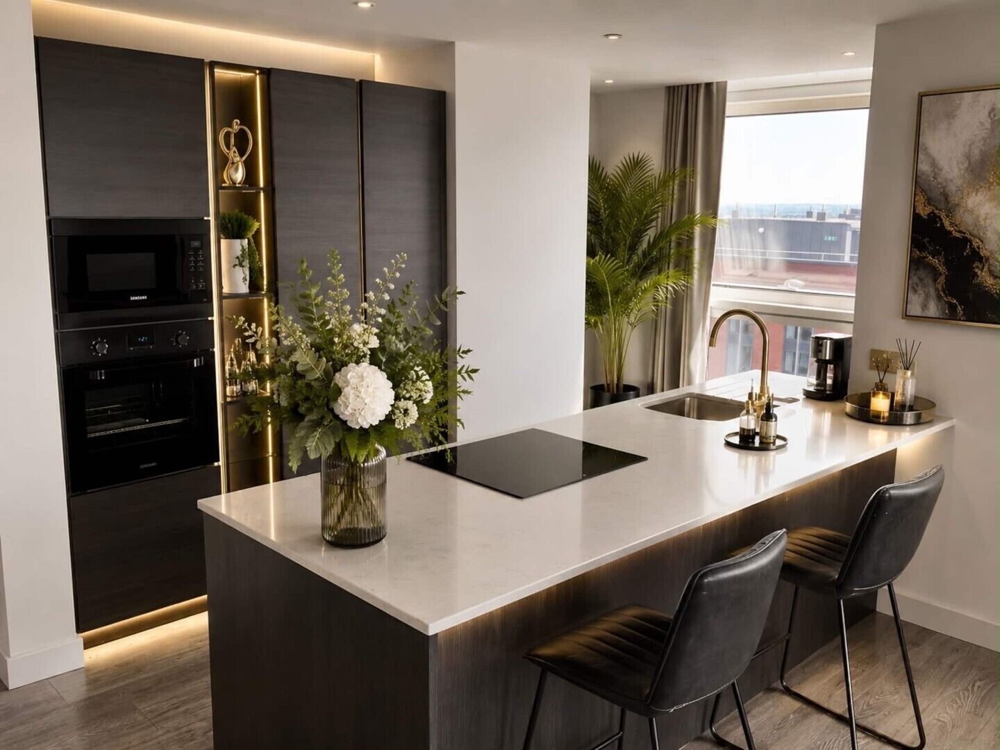 A modern kitchen with a central island, built-in appliances, and a view of the city.