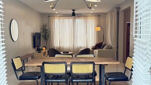 A modern dining area with a wooden table, black chairs, and a ceiling fan. - Private 3 Bedroom Tropical Luxury Villa · St. Kitts (Basseterre)