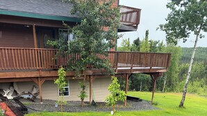 A residential property with a wooden deck, a small garden area with a gravel path, and a grassy lawn. - Lovely 2-bedroom apartment in Sterling perfect for your getaway (Sterling)