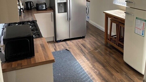A compact kitchen with a refrigerator, microwave, stove, and sink. - House 2 bedrooms Sleeps 4 with Parking (Bolton)