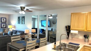 A compact living space with a kitchenette, dining area, and a ceiling fan. - Relax & Unwind~Cozy 1bed/1bath Condo with Beautiful Pond & Golf Views (Branson)