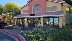A building with a 'Registration' sign, a covered entrance, and a landscaped garden. - Two bedroom deluxe resort at West flamingo Bay resort Las Vegas (Las Vegas)