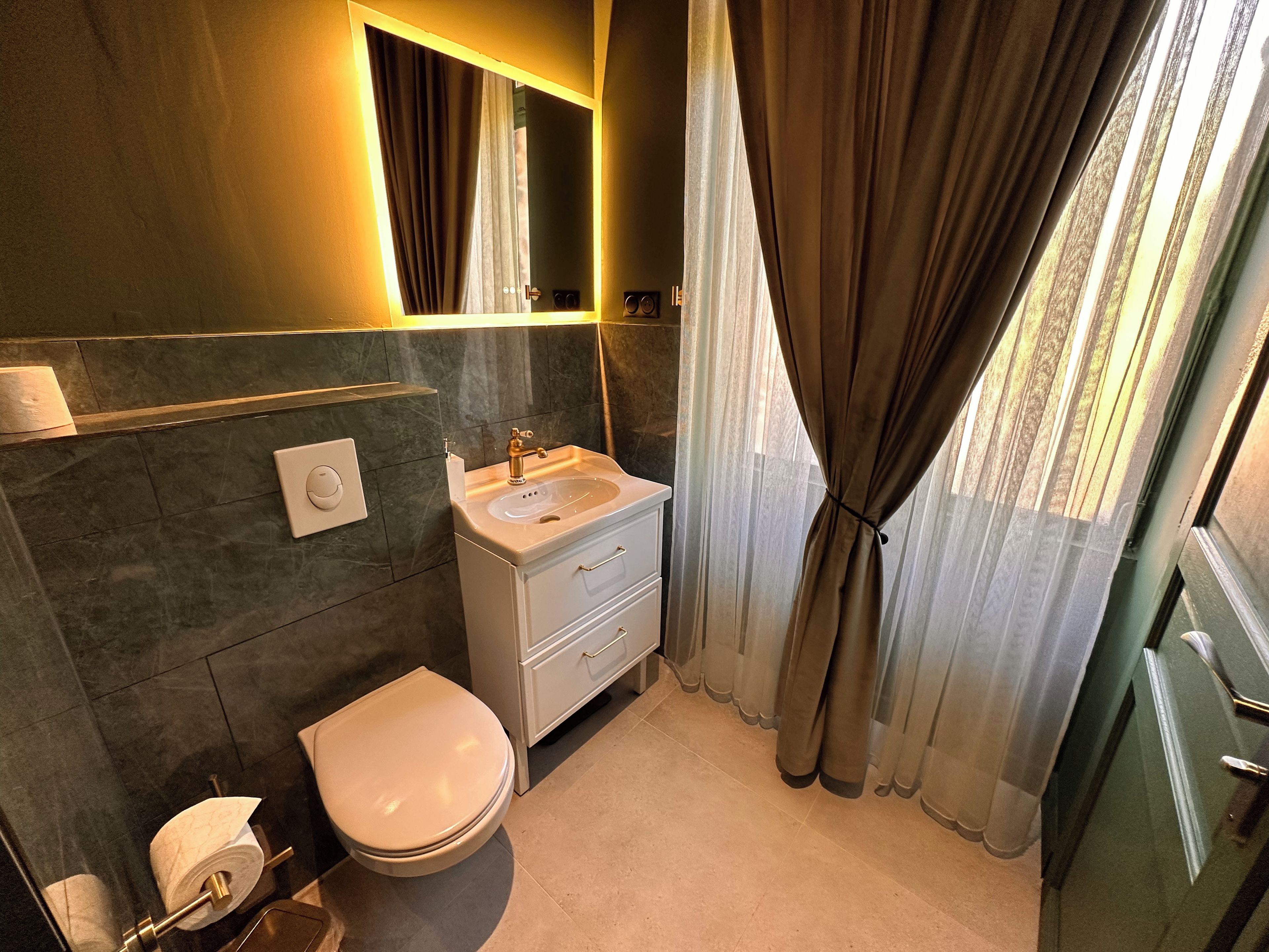 Ein Badezimmer mit Toilette, Waschbecken und Spiegel.