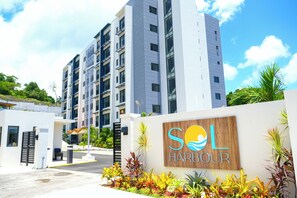 A modern building with a sign reading 'SOL HARBOUR' and a gated entrance. - Newly Built Apartment in the Heart of Ocho Rios (Ocho Rios)