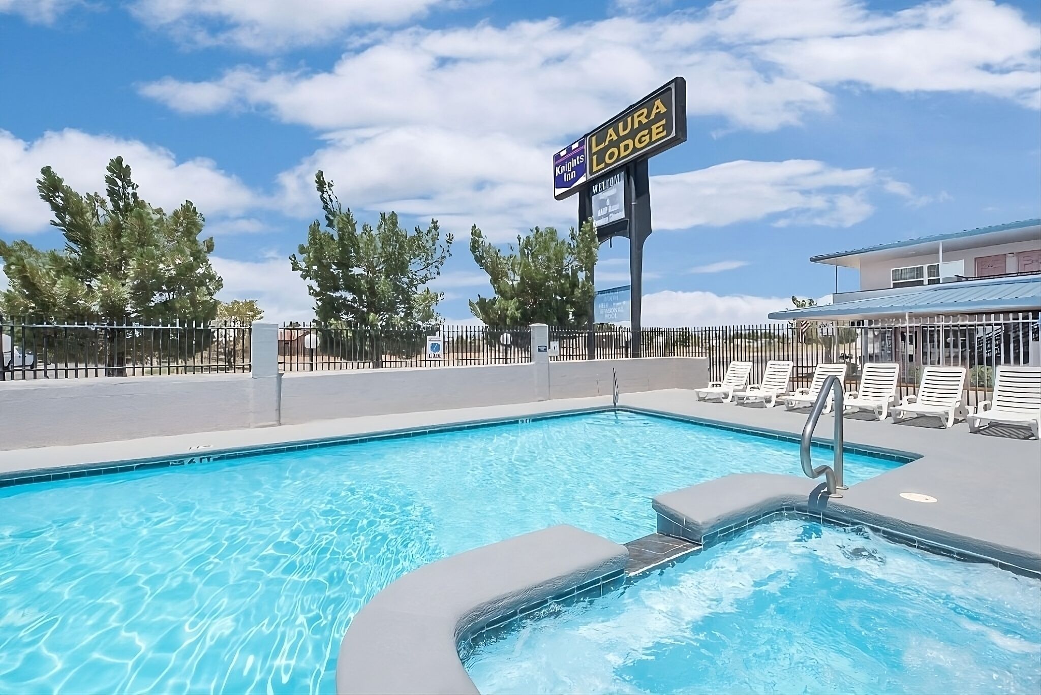 Unwind poolside under bright skies with lounge chairs nearby.
