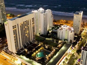 A high-rise hotel with multiple floors, a swimming pool, and a beach view. - Mantra on View: Surfers Paradise by Ready Set Stay (Surfers Paradise)