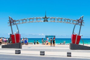 A beach entrance with a sign reading 'SURFERS PARADISE' and a star decoration. - The Orchid Stay Surfers (Surfers Paradise)