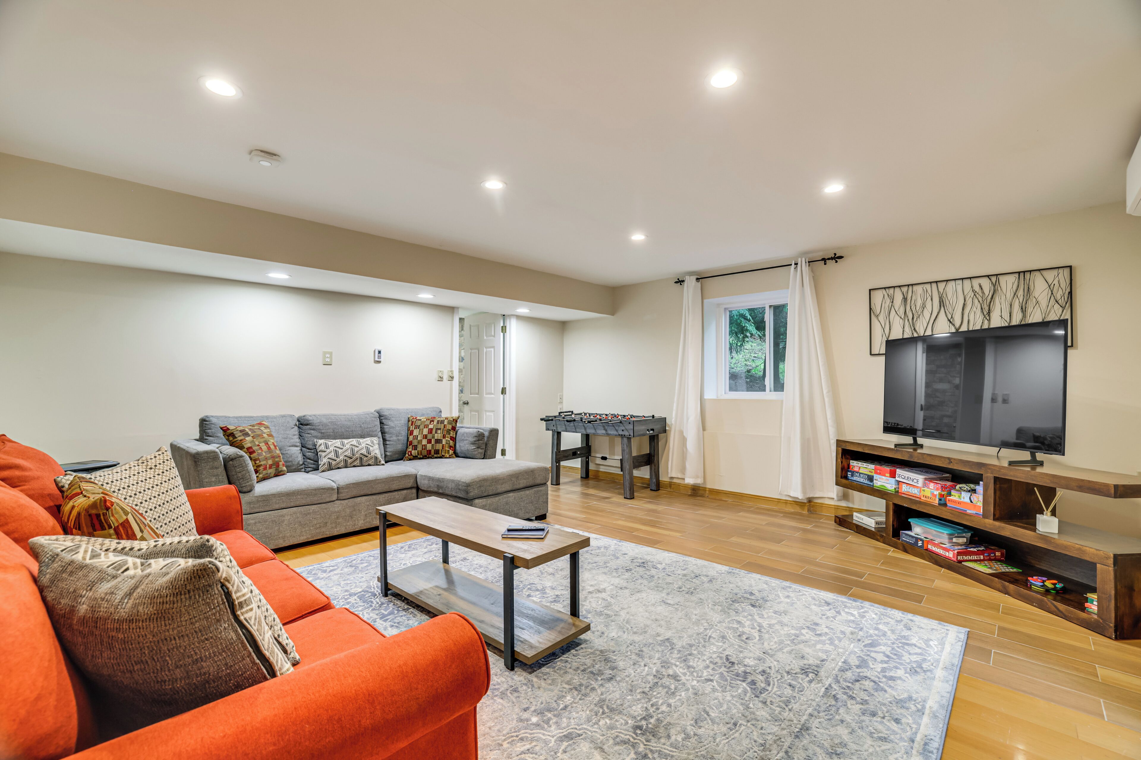 A living room with a sofa, coffee table, and a television.