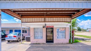 A small office building with a sign that reads 'OFFICE' and 'OPEN'.