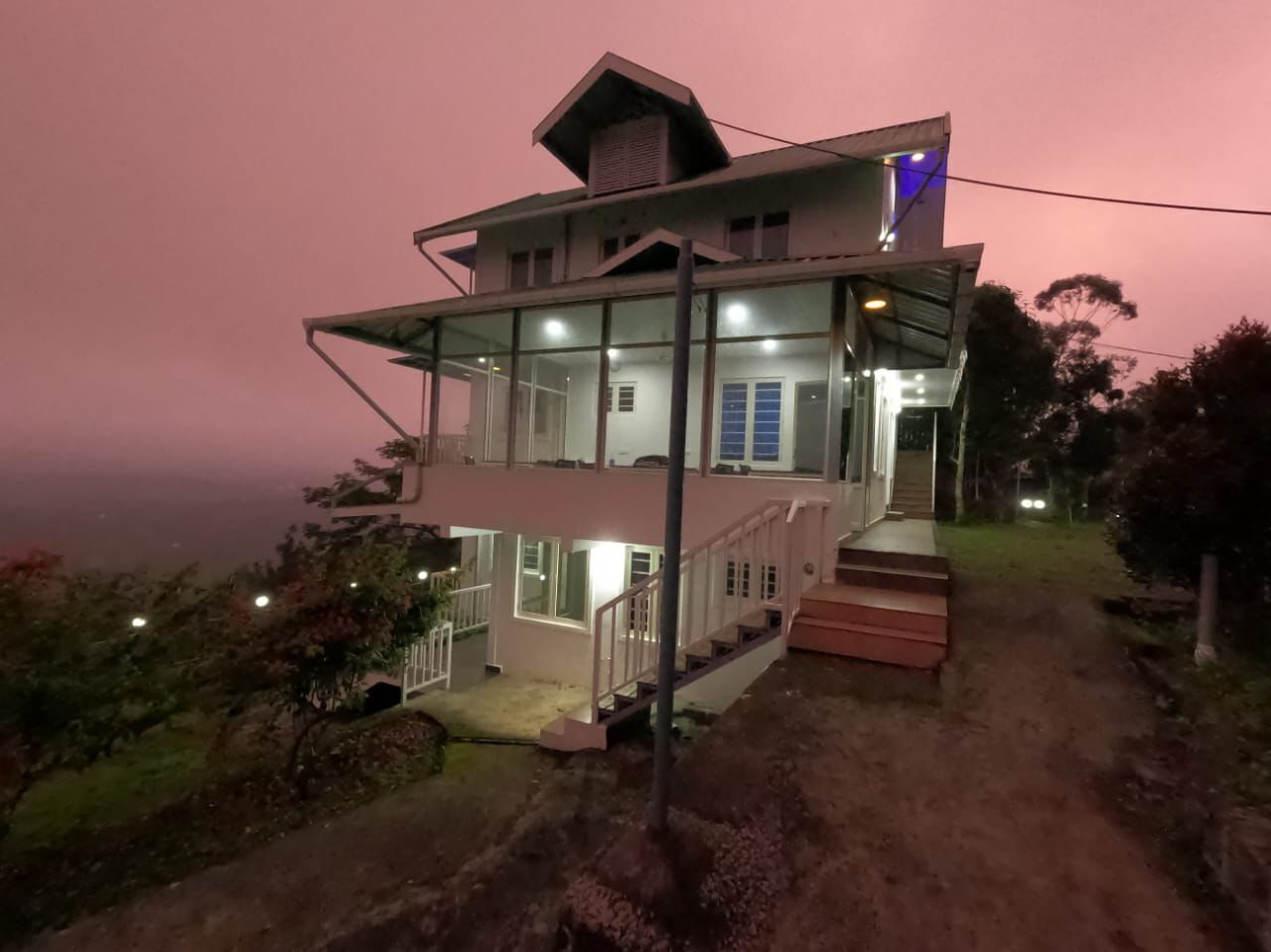 A two-story house with a balcony, a staircase, and a porch.
