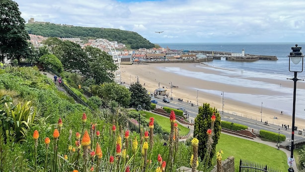 A coastal cityscape with a beach, promenade, and historic buildings. - 3 bedroom accommodation in Scarborough (Scarborough)