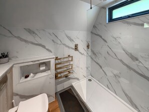 A bathroom with marble walls, a shower, a window, and a towel rack. - 2 bedroom accommodation in Pen-Y-Felin, near Mold (Pen-Y-Felin, near Mold)