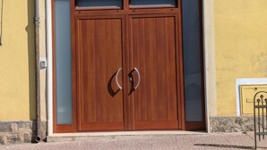 A double wooden door with glass panels and a metal handle. - Koras 142 - Guest House: A beautiful, bright apartment in the heart of Sennori (Sennori)