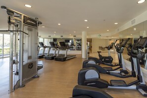 A gym with treadmills, ellipticals, and weight machines.