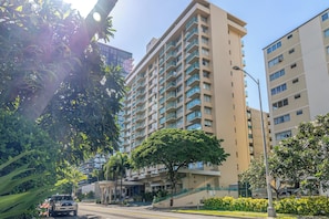 A multi-story building with balconies, a staircase, and a street in front. - 9th Floor Studio in the Middle of Waikiki (Honolulu)
