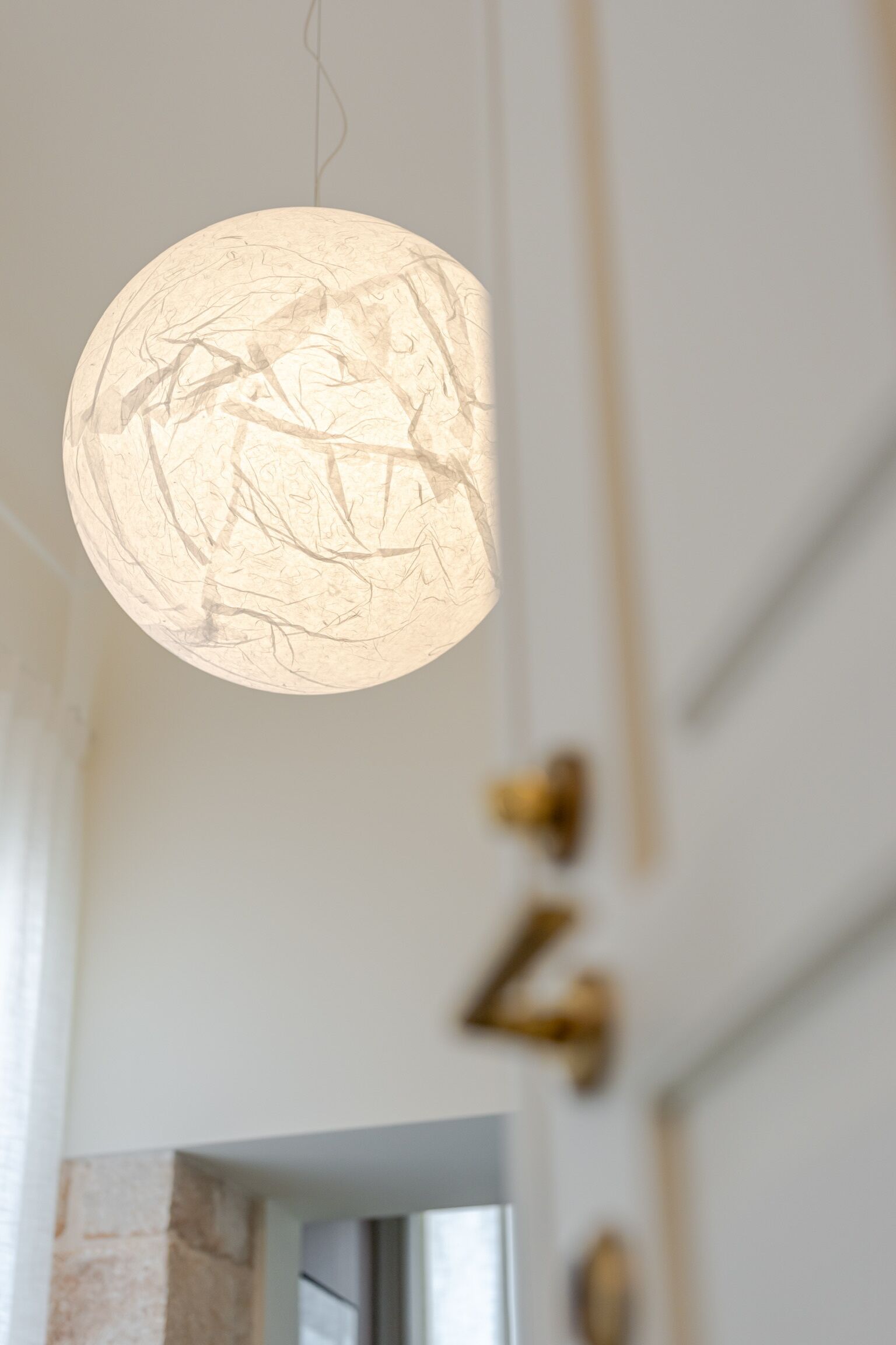 A circular pendant light with a textured design.