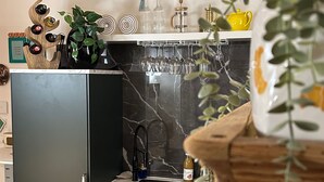 A compact kitchen with a built-in oven, a sink, and a wooden ceiling. - Villa Barka – 5-Star Vacation Rental in the Bavarian Forest Near the National Park (Eppenschlag)