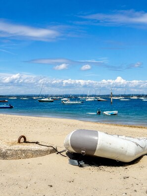 A beach with a lifebuoy on the sand and several boats in the water. - Fantastic Large Chichester Harbour View House. 2 minutes to beach. (Hayling Island)