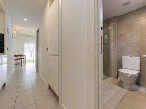 A modern bathroom with a toilet, shower, and glass door. - Calafont by Interhome (Salou)