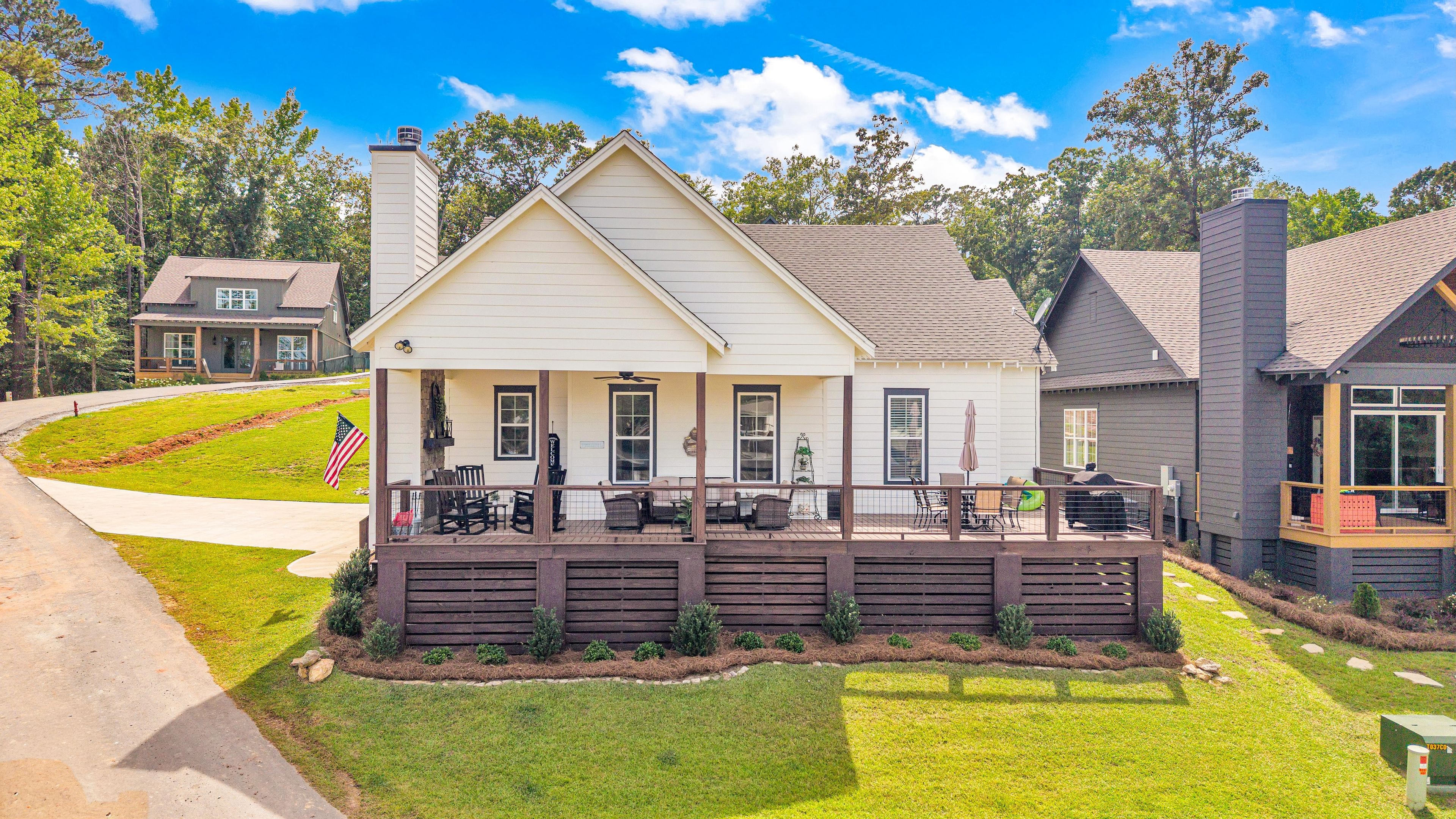 A two-story house with a porch, a chimney, and a well-maintained lawn.