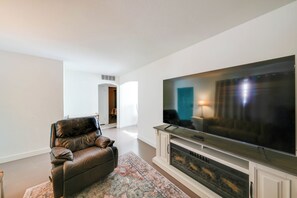 A living room with a leather sofa, a flat-screen TV, and a fireplace. - Duplex w/ Pet-friendly Yard, 5 Mi to Dtwn Phoenix! (Phoenix)