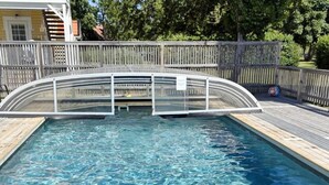 A swimming pool with a wooden deck and a wooden fence. - 4 Star Holiday Home in Gotlands Tofta (Gotlands Tofta)