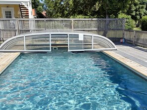 A swimming pool with a wooden deck and a wooden fence. - 4 Star Holiday Home in Gotlands Tofta (Gotlands Tofta)