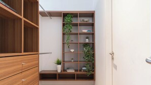 A wooden bookshelf with multiple shelves, some containing books and others with decorative items. - MOT Concepcion Arenal (Buenos Aires)