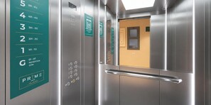 An elevator interior with floor numbers and a reception label.