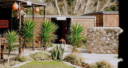 Flow @ Tides Glamping is a secluded glamping retreat surrounded by trees.