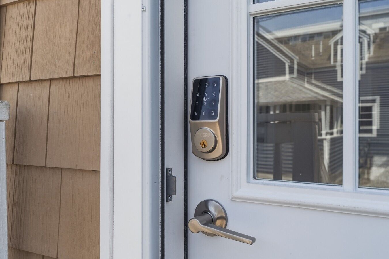 A door with a modern electronic keypad lock and a keyhole.