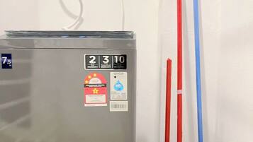 A refrigerator with a digital display, a water dispenser, and a mop bucket.
