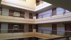 A multi-level atrium with glass railings and a central open space.