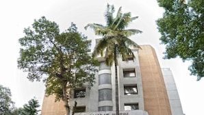A multi-story building with a sign reading 'The Samrat Hotel.'