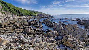 Un paysage côtier rocheux, avec des falaises et un ciel dégagé.
