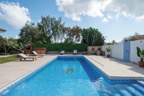 A rectangular swimming pool with a tiled edge, surrounded by a patio with lounge chairs and a small wooden structure. - LXR Villa Mirador del Sur, 5 Bedrooms, Ocean Views (Marbella)