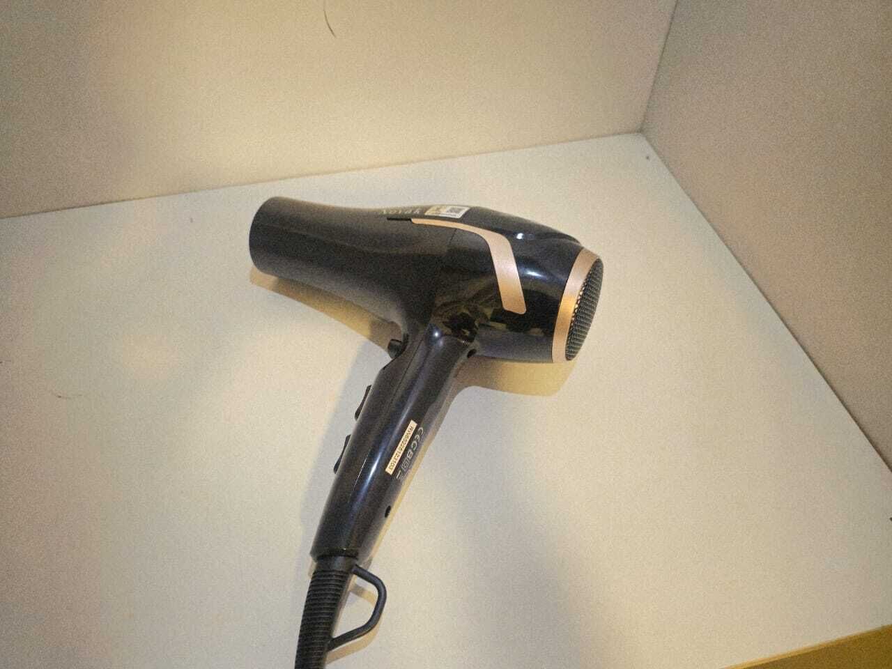 A hair dryer on a white surface.