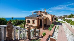 A coastal house with a balcony, solar panels, and a view of the sea. - LXR Villa Sirena Oceanfront 3-Bedroom (El Faro)