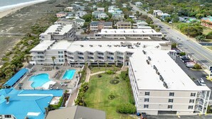 A coastal hotel with multiple buildings, a swimming pool, and a view of the beach. - Ocean‑View Condo in Beachside Colony • Pools • Steps to the Sand • Restaurant (Tybee Island)