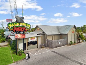 A building with a sign reading 'Hammerhead Freds' and a parking sign indicating 'PARKING ONLY.' - The Blue Drop ~ Spacious 3-BR Coastal Retreat! (Panama City Beach)