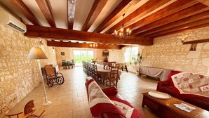 A spacious living area with a fireplace, a dining area, and a view of the outdoors. - Large house, pets allowed - 14 guests (Pouzay)