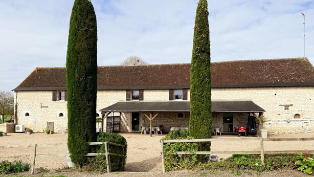 A stone building with a covered outdoor seating area and two tall, narrow trees in front. - Large house, pets allowed - 14 guests (Pouzay)